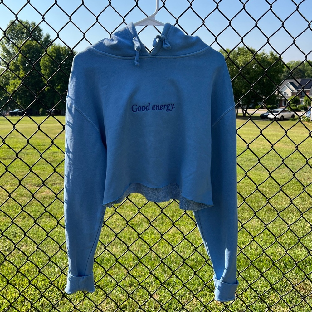 “Good Energy” hoodie in size large with wording “Thru the Lows” on one sleeve.